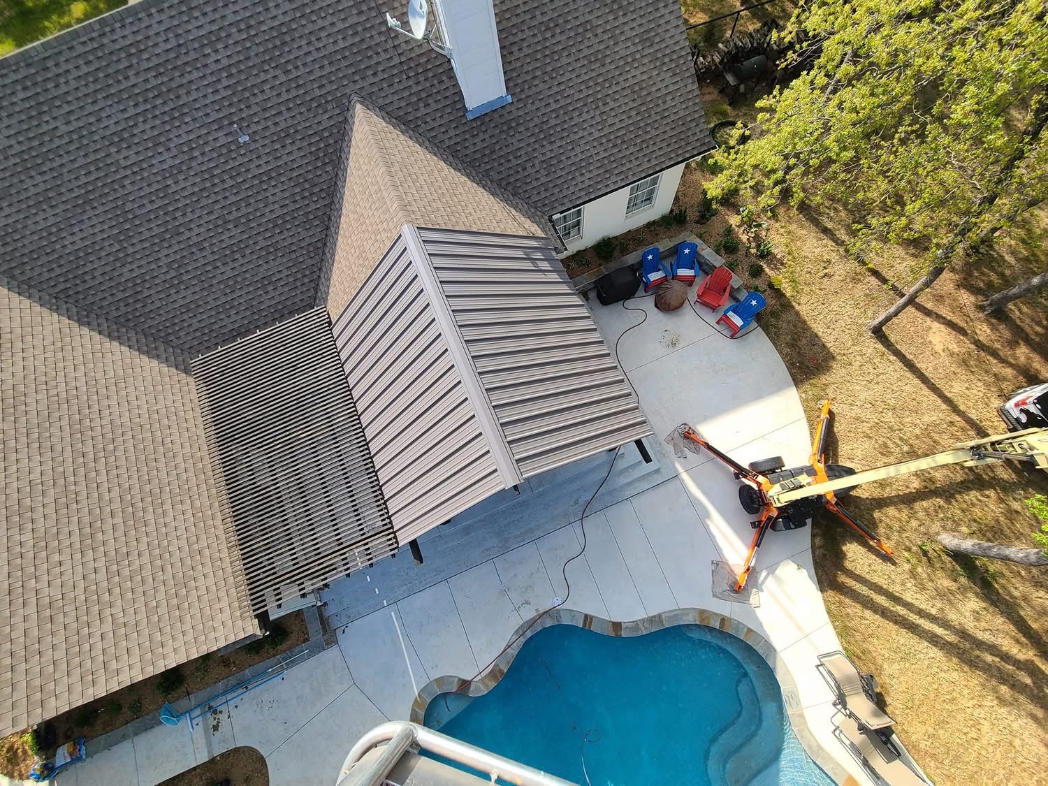 Overhead view of a metal-roof patio cover beside a backyard pool