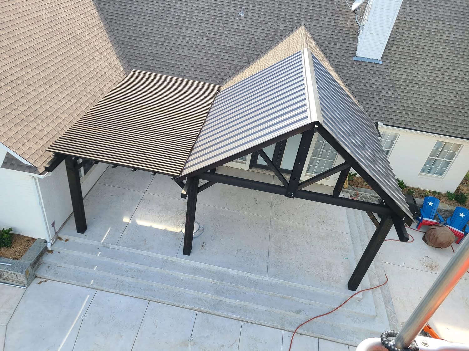 Aerial view of a dark timber gable patio cover attached to a home