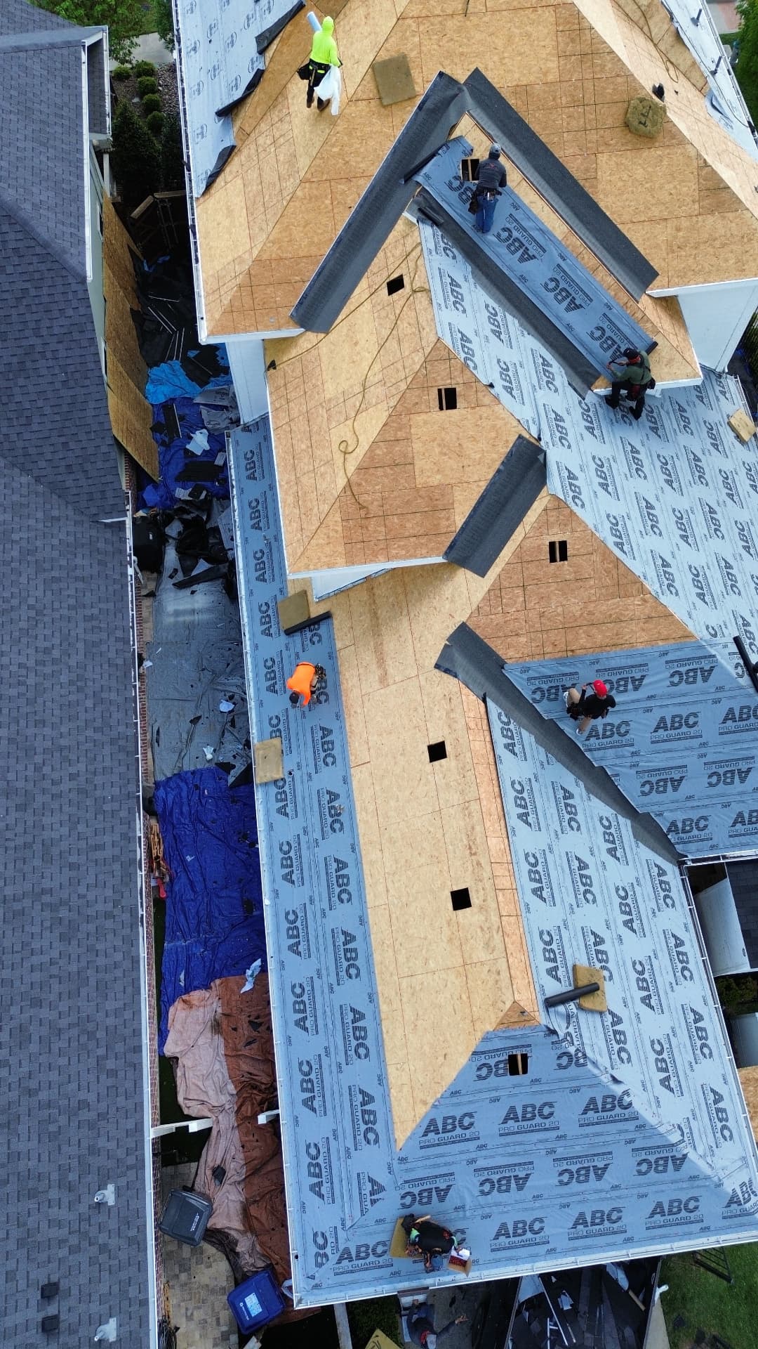 Yearby roof replacement in progress, aerial view 2: exposed decking and roofing underlayment