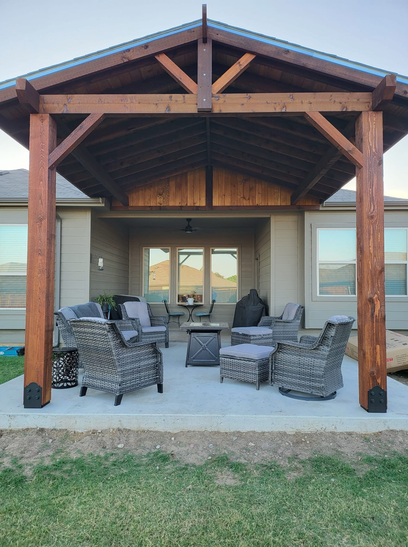 Timber patio cover with a wood ceiling, ceiling fan and outdoor seating