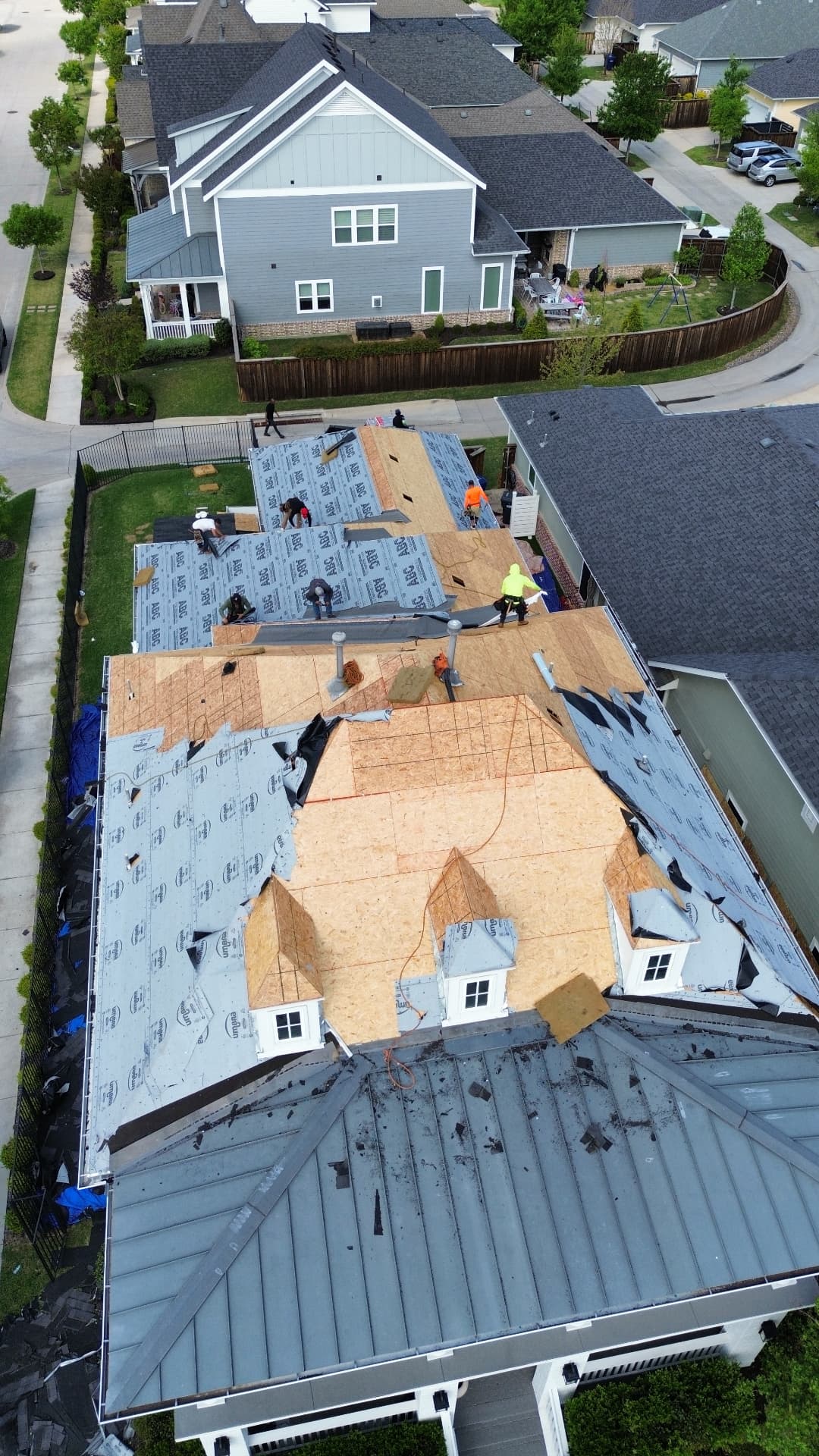 Yearby roof replacement in progress, aerial view 5: exposed decking and roofing underlayment