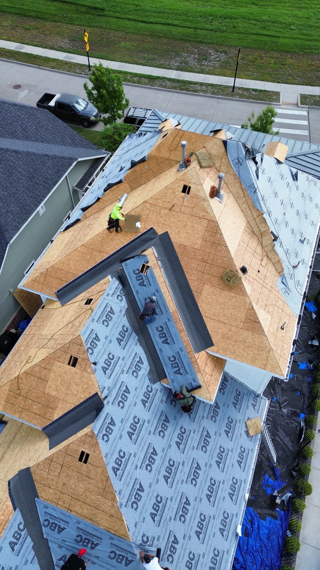 Yearby roof replacement in progress, aerial view 4: exposed decking and roofing underlayment