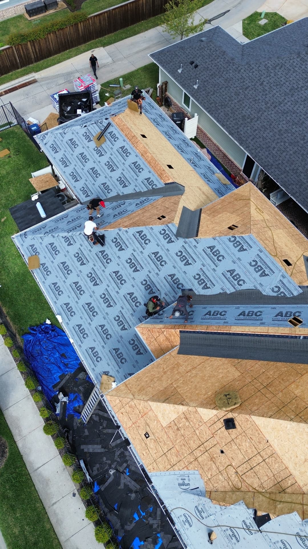 Yearby roof replacement in progress, aerial view 6: exposed decking and roofing underlayment