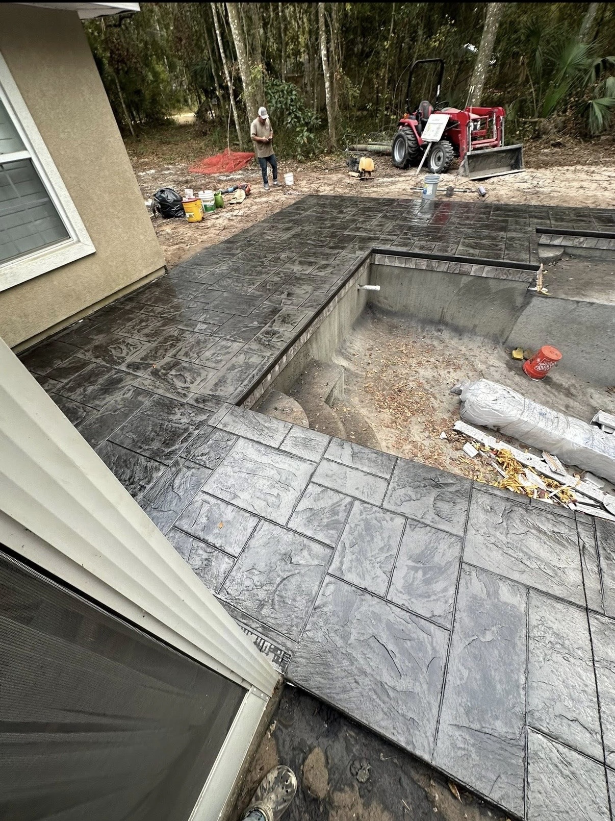 Overhead view of stamped concrete paving beside a home and pool