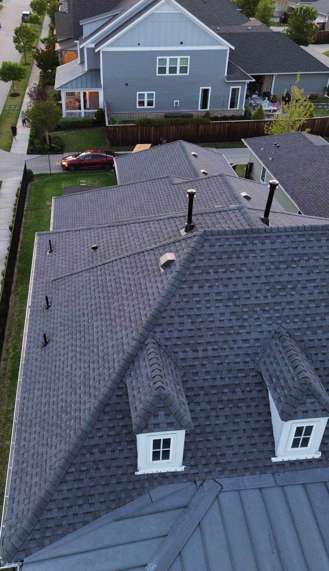 Aerial view of finished shingle roof slopes around a dormer
