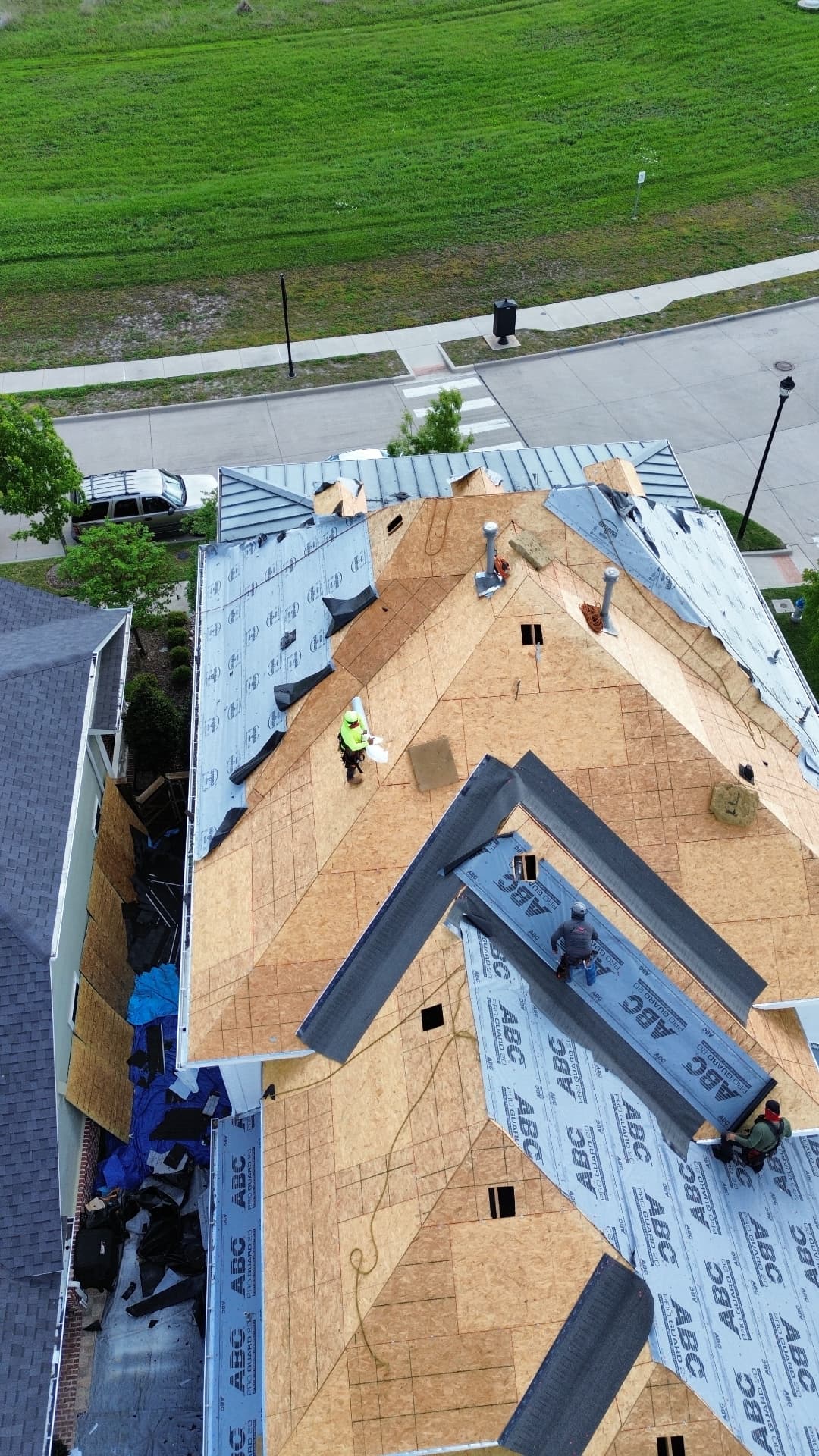 Yearby roof replacement in progress, aerial view 3: exposed decking and roofing underlayment
